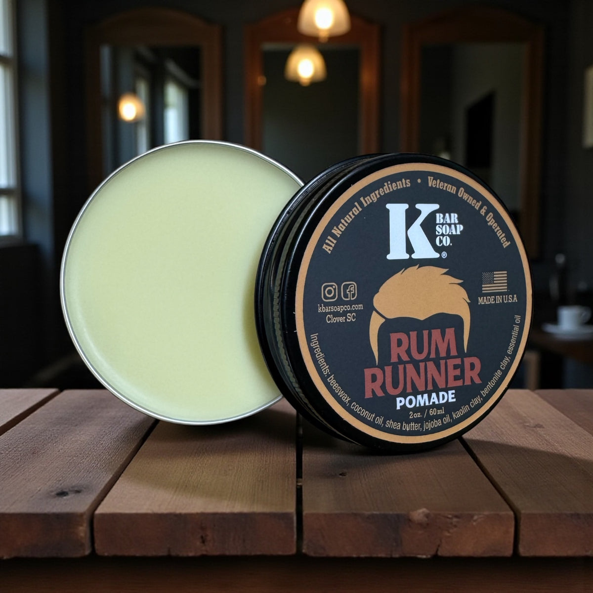 Rum Runner natural hair pomade, open tin on a wood table