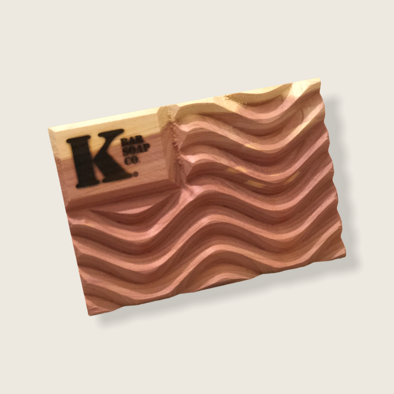 natural soap bar on ventilated soap dish in hard-water shower