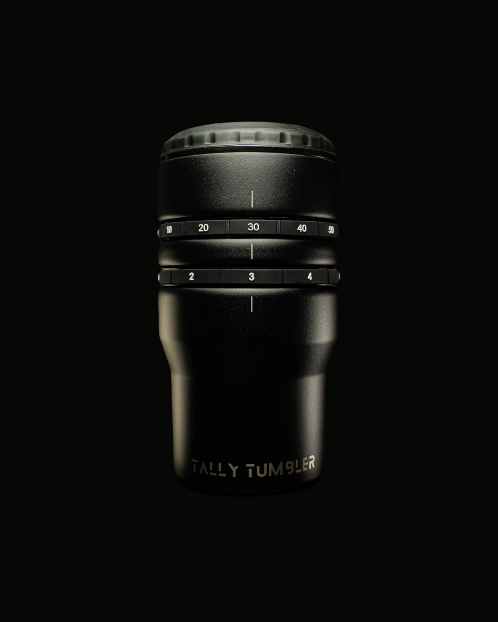 Black tumbler with measurement markings on a black background
