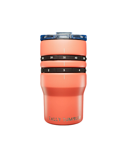 Coral-colored tumbler with measurement bands on a white background