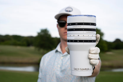 Person holding a Tally Tumbler with a golf course in the background