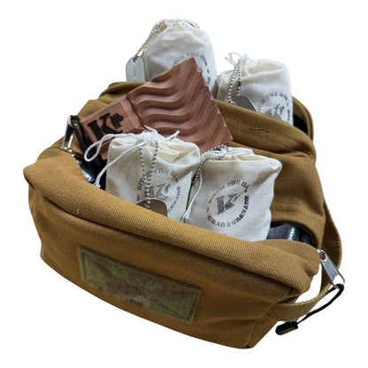 A tan canvas pouch filled with white drawstring pouches and a brown textured item, photographed on a plain white background.