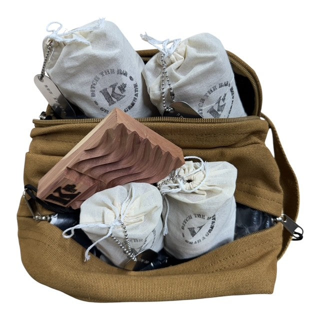 
                  
                    A tan canvas shoulder bag shown open, filled with several small off-white drawstring pouches printed with a circular logo and a wooden folding tray, photographed on a plain white background.
                  
                