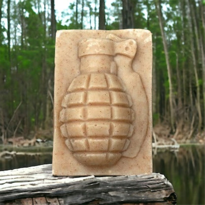 Fu*k Bugs citronella grenade soap bar on a log by a forest pond