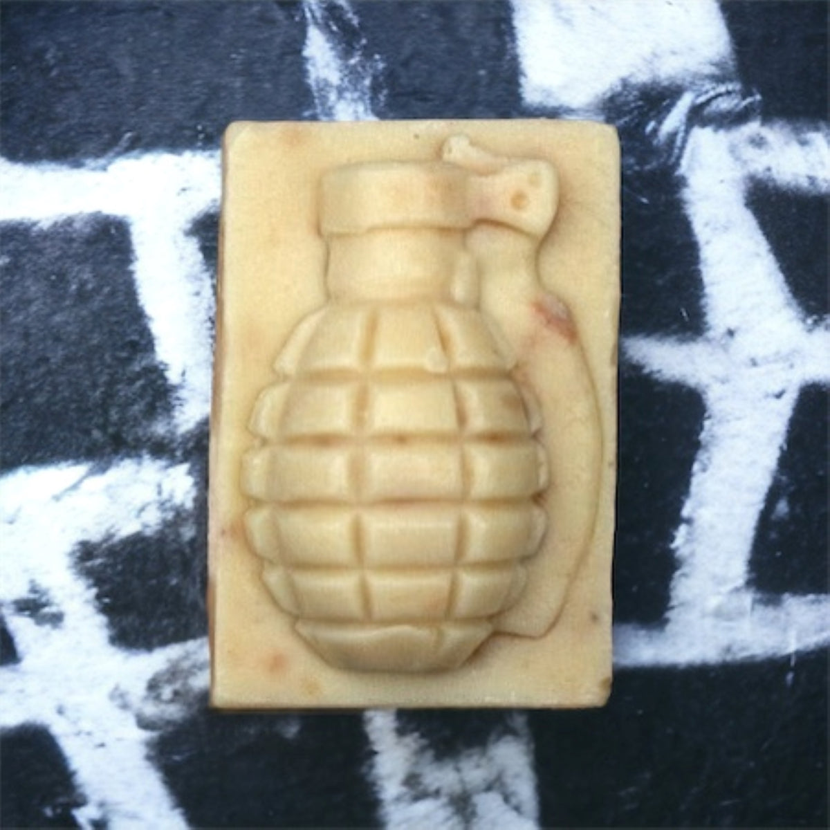 Fluster Cuck grenade soap bar on a black and white graffiti background