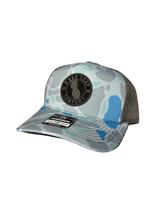 Trucker hat with camouflage design and brand logo on a white background