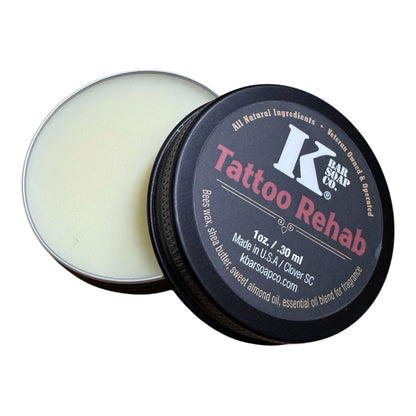 Tattoo Rehab balm in a black container with visible branding on a white background