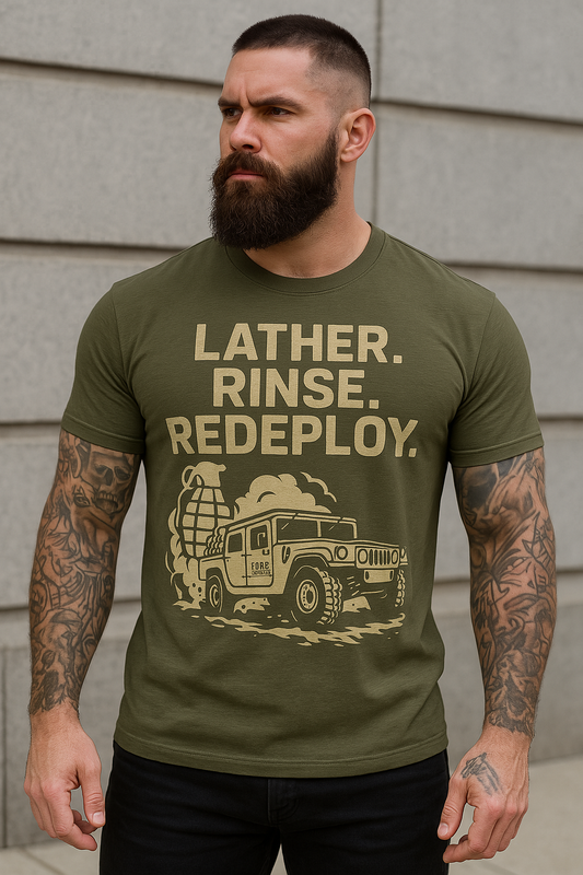 A man with a beard and tattoos wearing a green t-shirt with the text 'LATHER, RINSE, REDEPLOY' on it, featuring an image of a vehicle.