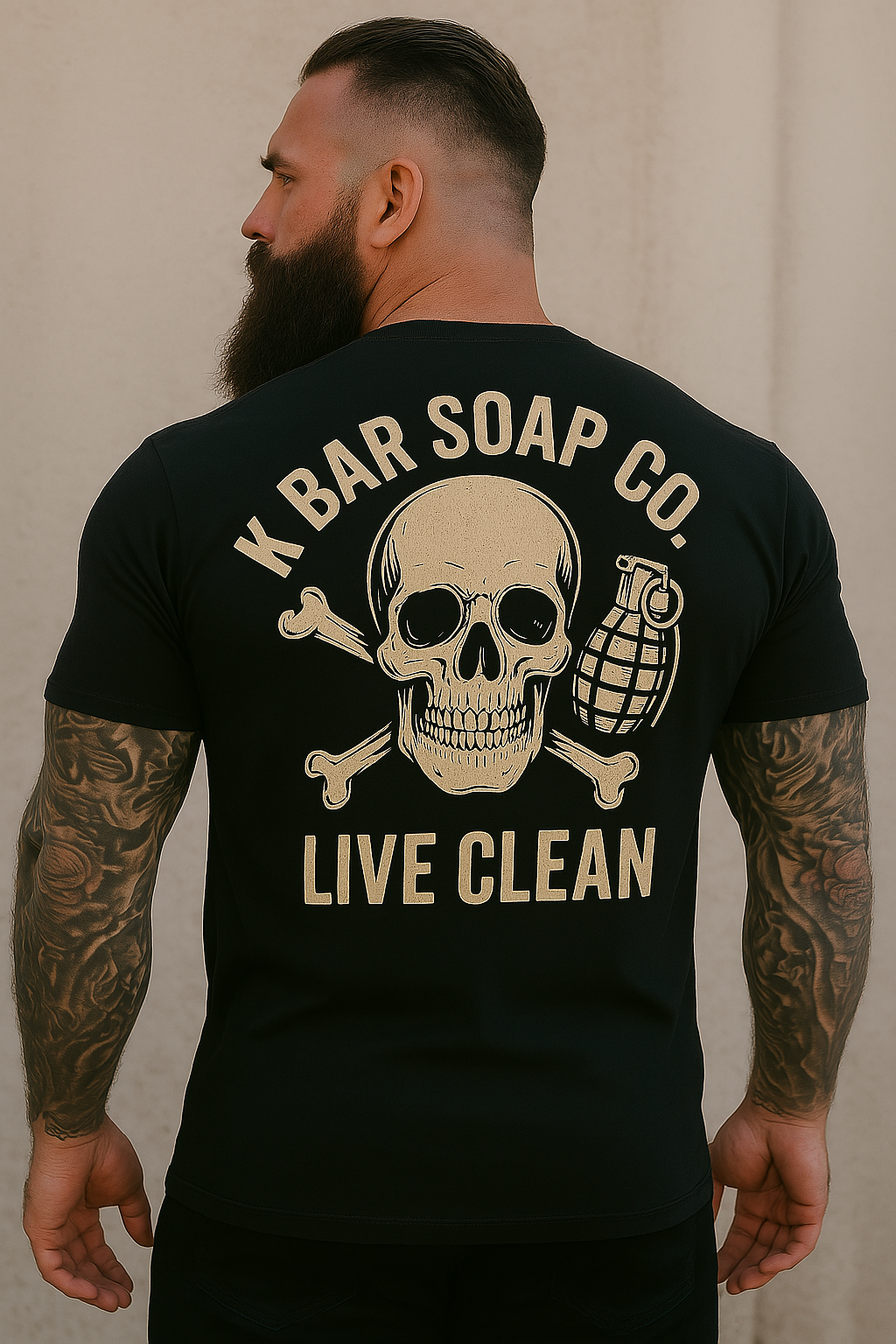 A person wearing a black t-shirt with 'K BAR SOAP CO. LIVE CLEAN' graphic on the back, featuring a skull and crossbones design.