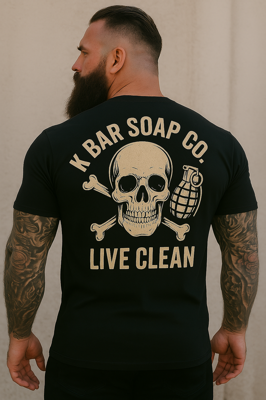 A person wearing a black t-shirt with 'K BAR SOAP CO. LIVE CLEAN' graphic on the back, featuring a skull and crossbones design.