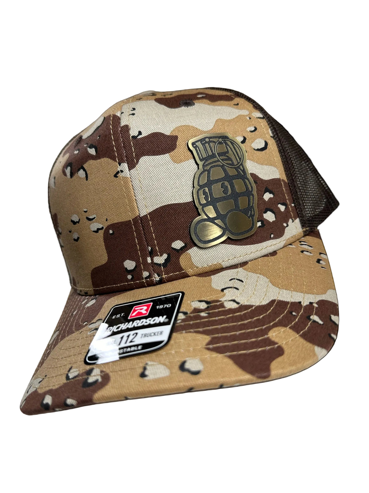 Camouflage baseball cap with grenade emblem and brand label on a white background