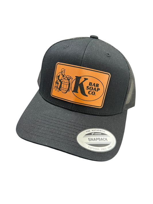 Black cap with orange and white logo on a white background