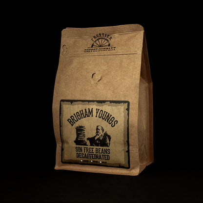 A package of Brigham Young's Decaf coffee with a dark, rustic brown paper bag and a label featuring an image of Brigham Young.