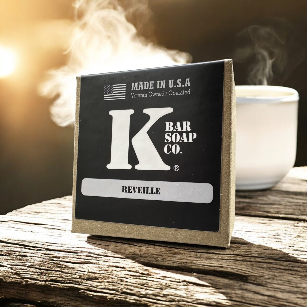Reveille coffee bar soap box next to a steaming cup of coffee