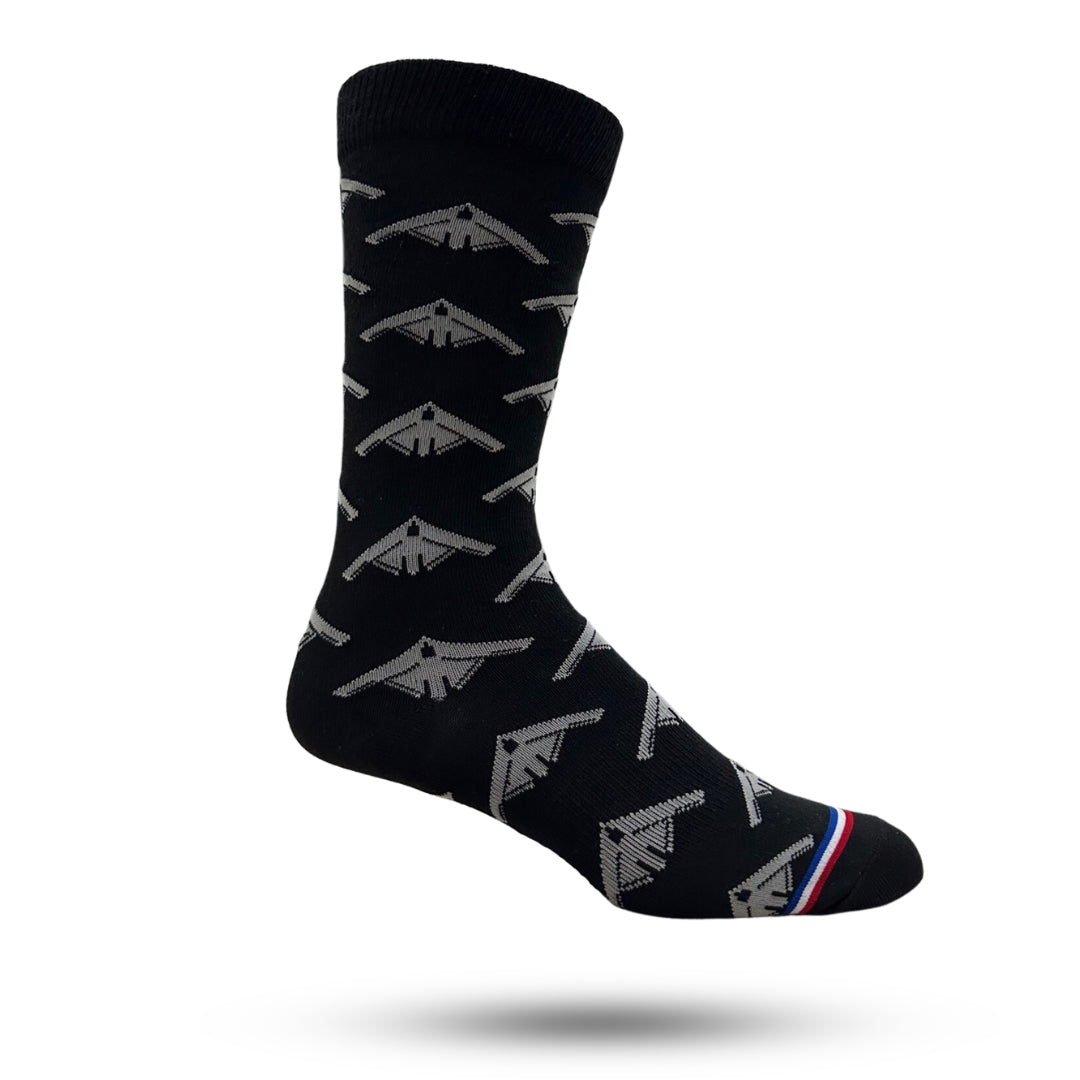 A pair of black casual crew socks with white and silver bomber plane patterns.