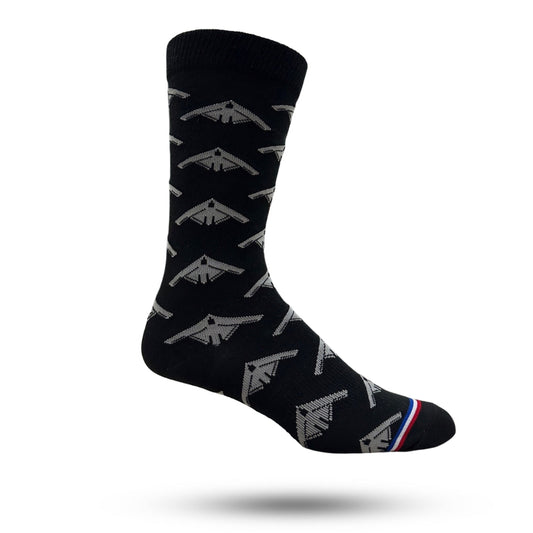 A pair of black casual crew socks with white and silver bomber plane patterns.