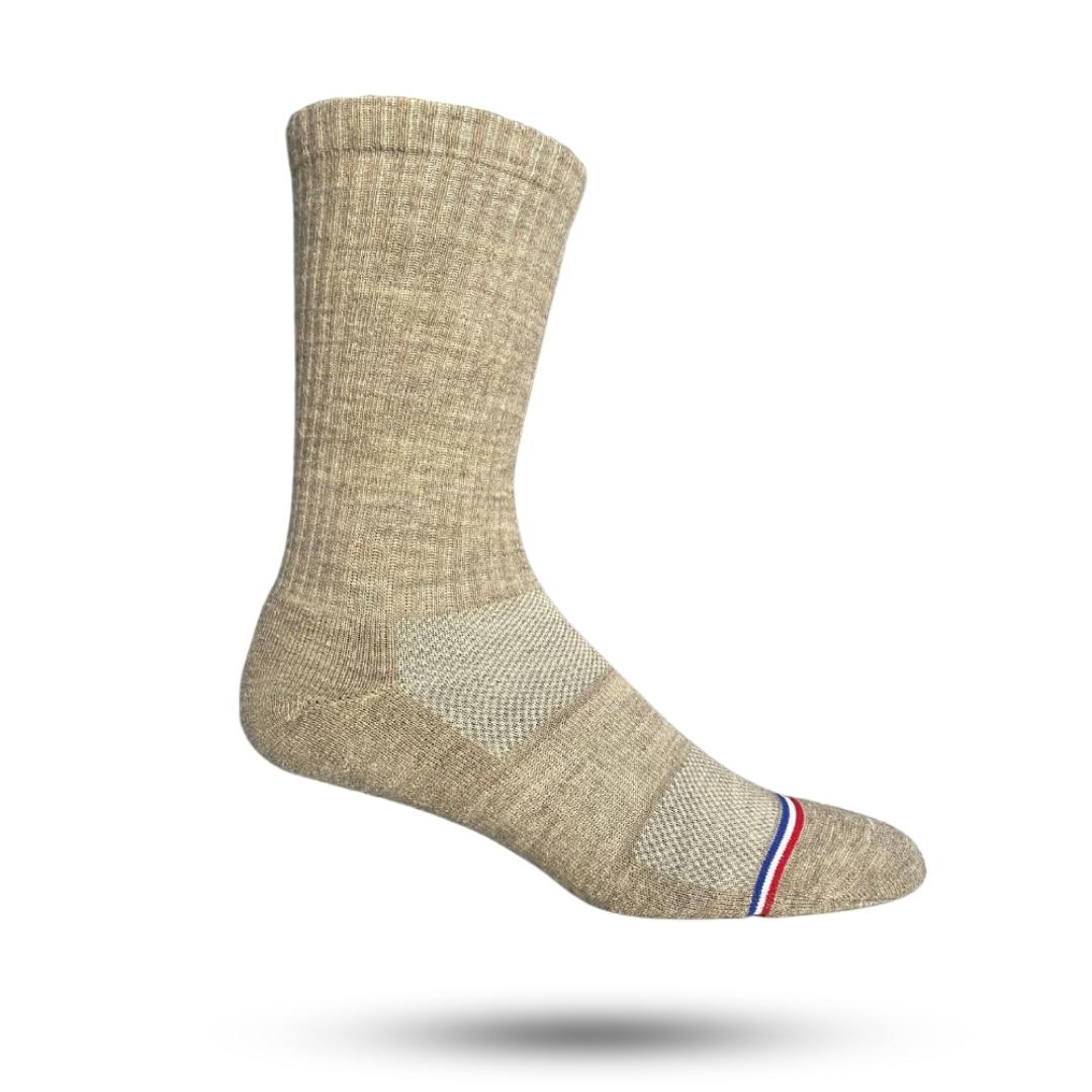 A pair of tan merino wool socks with a striped design and a reinforced heel and toe seam.