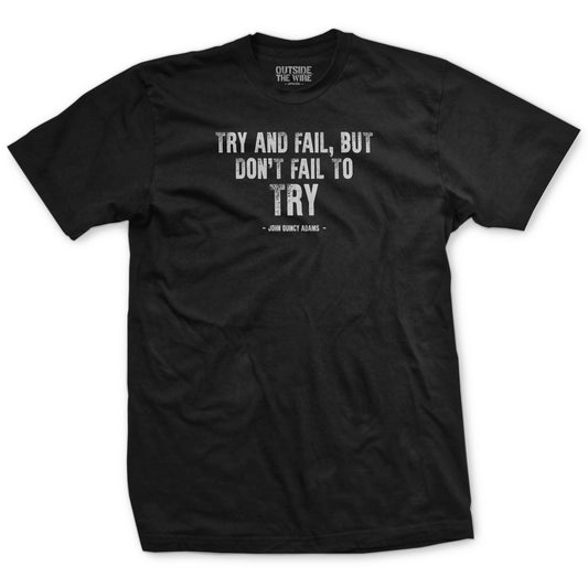Black T-shirt with a text design featuring the quote 'TRY AND FAIL, DON'T FAIL TO TRY' along with the name 'JOHN QUINCY ADAMS'.