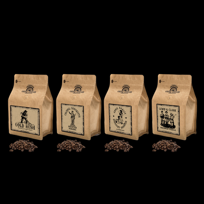 Four bags of Frontier Coffee with different roast levels indicated by the labels, ranging from light to dark, displayed in a row with coffee beans scattered in front of each bag.