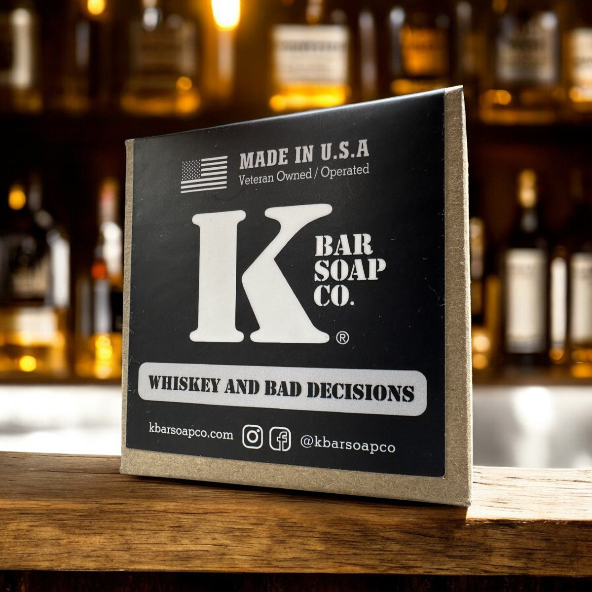 Whiskey & Bad Decisions bar soap box on a bar with whiskey bottles