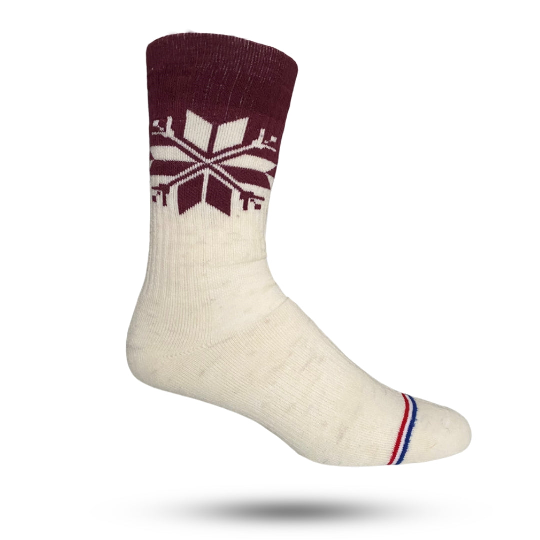 A pair of white crew socks with a snowflake pattern on the side, cushioned sole, and reinforced heel and toe areas.