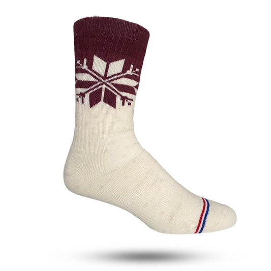 A pair of white crew socks with a snowflake pattern on the side, cushioned sole, and reinforced heel and toe areas.