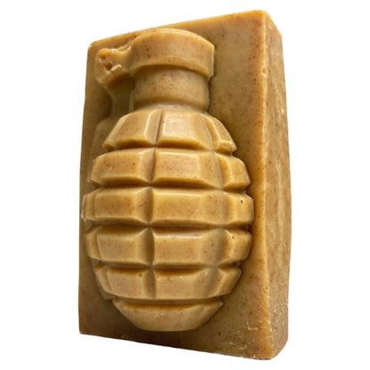 A rectangular bar of soap with a molded grenade design on the front, shown against a plain white background.