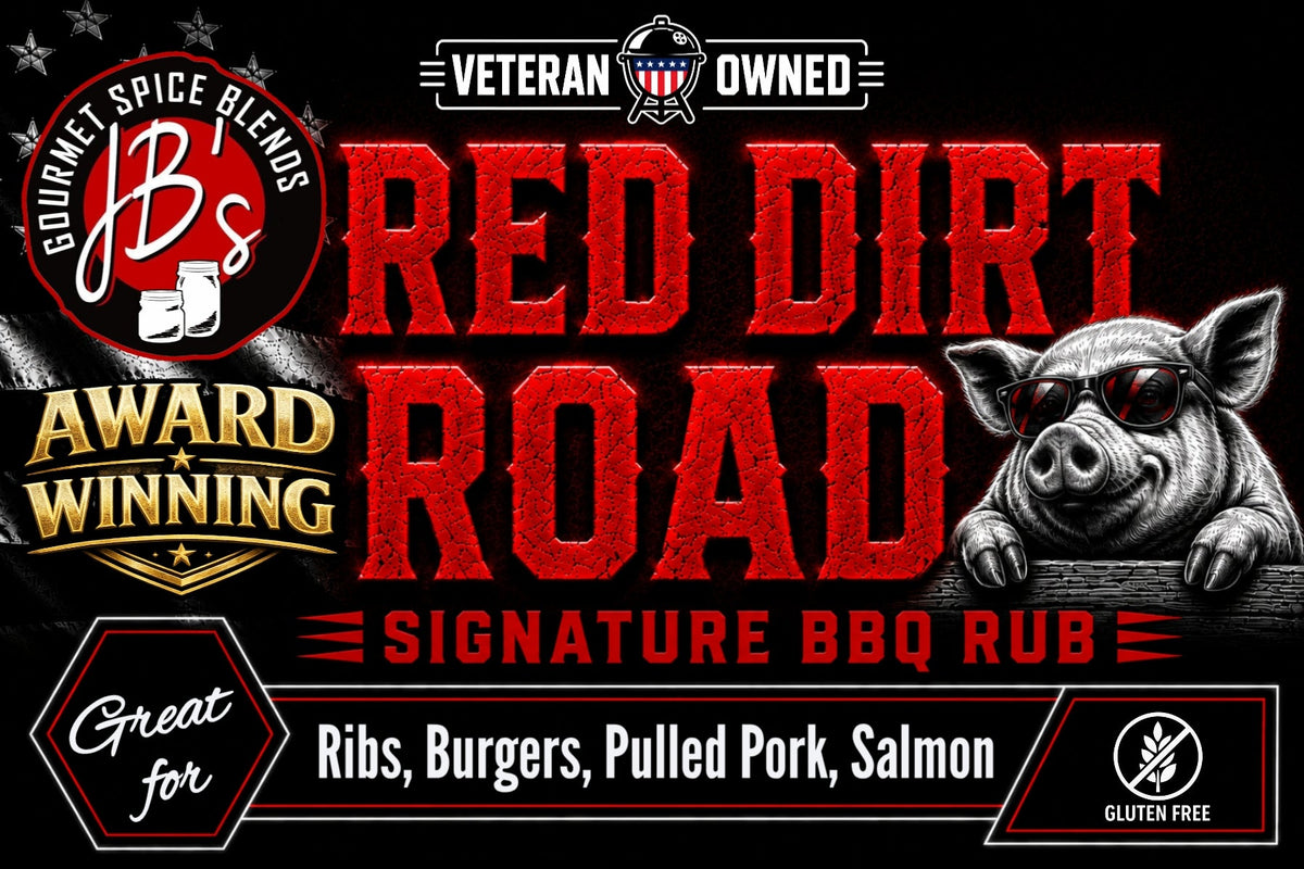 Promotional graphic for JB's Red Dirt Road Signature BBQ Rub, featuring bold red and white text on a black background with a pig illustration and badges for veteran-owned and award-winning status.