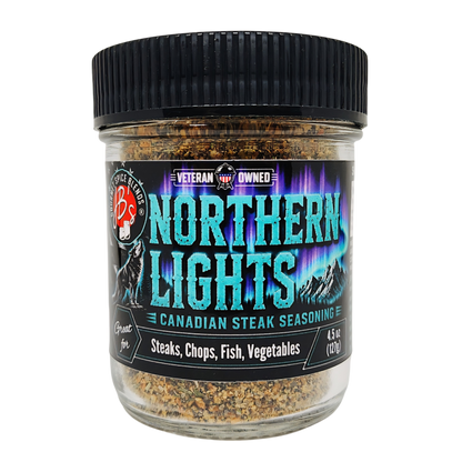 A jar of Northern Lights Canadian Steak Seasoning with a black ribbed lid and a black label featuring teal and purple text, set against a plain white background.
