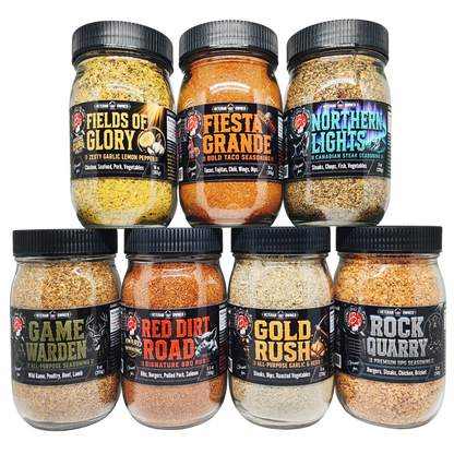 Six glass jars of Crispin's Smokehouse smoked meats and seasonings arranged in two rows on a white background. The top row contains Fields of Glory, Fiesta Grande, and Northern Lights rubies; the bottom row contains Game Warden, Red Dirt Road, Gold Rush, and Rock Quarry rubies.