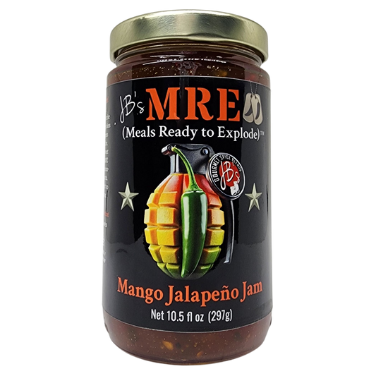 A glass jar of JB's MRE Mango Jalapeño Jam with a gold metal lid and a black label featuring a grenade and chili pepper graphic.