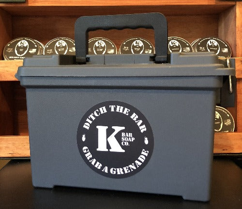 
                  
                    5.56 Ammo Can with K Bar logo with shelf of beard grease in back
                  
                