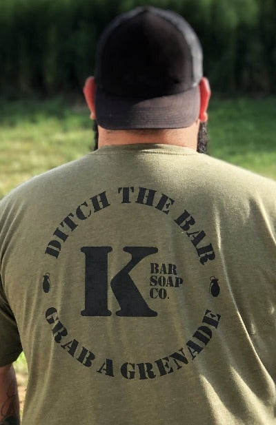 
                  
                    Back of Man with OD Green Triblend K Bar logo shirt outside
                  
                
