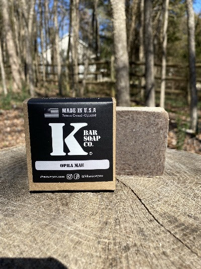 
                  
                    K Bar Opha Mae Soap Bar in black packaging with logo
                  
                