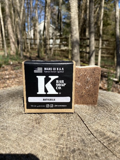 
                  
                    K Bar Reveille Soap Bar in black packaging with logo
                  
                