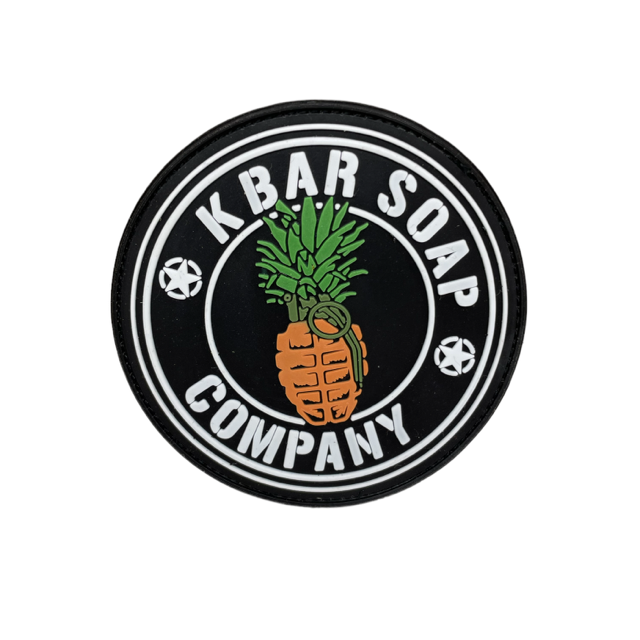 A circular black and white patch with the text 'KBAR SOAP COMPANY' and an illustration of a pineapple in the center