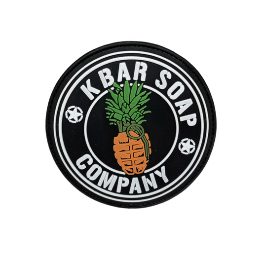 A circular black and white patch with the text 'KBAR SOAP COMPANY' and an illustration of a pineapple in the center